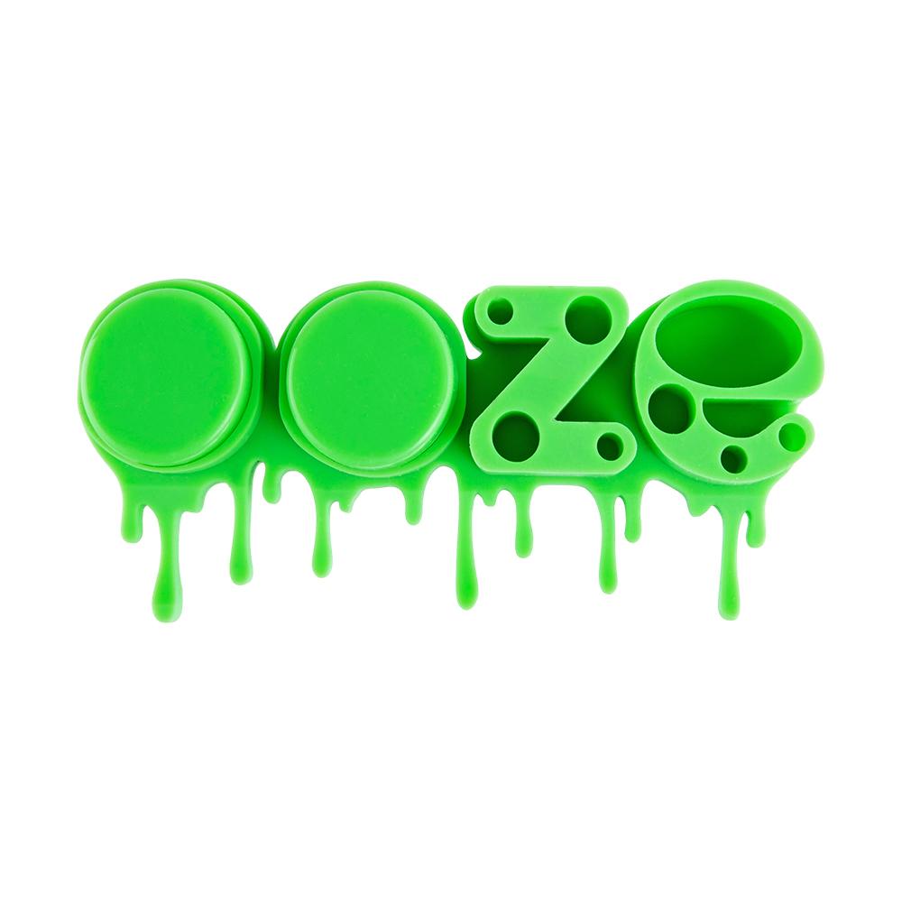 Front angled view of the Ooze Stash Station Silicone Organizer in vibrant green. This premium tabletop storage caddy is engineered with custom slots to safely secure your lighters, dab tools, vape cartridges, and smoking accessories in one place.