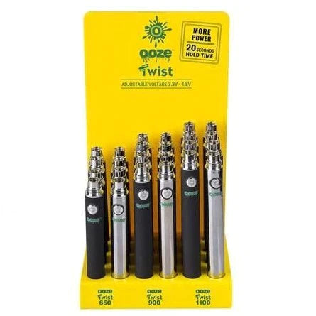 Front view of the Ooze Twist 510 battery 24-count acrylic display filled with assorted vibrant and metallic colors. This retail-ready wholesale display provides smoke shops with highly popular, reliable vape pen batteries perfect for checkout counters.