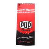 Front view of the POP Papers Strawberry Jam rolling papers booklet in a bold red finish. This product relies on botanical extracts rather than harsh chemical sprays to generate its recognizable aromas.
