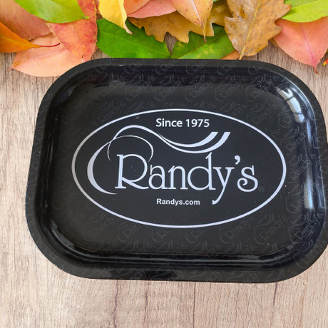 Front overhead view of the Randy's small rolling tray in classic black featuring the iconic brand logo. This compact, heavy-duty metal tray provides a smooth, flat surface to efficiently prepare and roll your dry herbs.