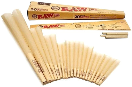 Overhead flat lay view of the RAW 20 Stage RAWket Launcher cones in natural light brown. Displaying the seven distinct sizes included in the assortment side-by-side, these unbleached cones feature a proprietary crisscross watermark for a slow, even burn.