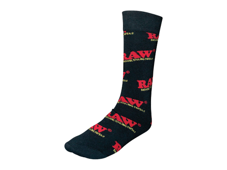 Front angled view of the RAW Black Crew Socks Hemp Blend Apparel laid flat. These premium mid-calf crew socks feature a comfortable, breathable hemp-cotton blend fabric with the signature red RAW logo boldly knitted near the top cuff.