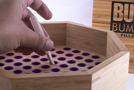 Angled overhead view of the RAW Buddies Bump Box in natural light wood grain with the lid closed. This efficient wooden cone filler allows users to easily pack up to 34 standard 1 1/4 size pre-rolled cones simultaneously.