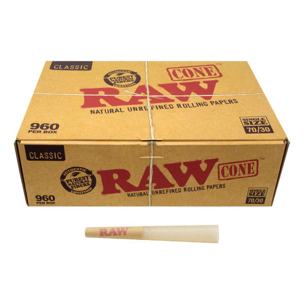 Front angled view of the RAW Classic Dogwalker 70/30 Bulk Cones 960-count box in natural kraft brown packaging. Measuring 70mm in length with an extended 30mm tip, these unbleached, mini-sized cones are perfectly proportioned for quick, individual smoke sessions.