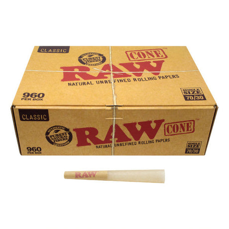 Front angled view of the RAW Classic Dogwalker 70/30 Bulk Cones 960-count box in natural kraft brown packaging. Measuring 70mm in length with an extended 30mm tip, these unbleached, mini-sized cones are perfectly proportioned for quick, individual smoke sessions.