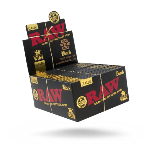 Front angled view of the RAW Classic King Size Wide Rolls 12-count display box in natural kraft brown packaging with red branding. This retail-ready display box provides smoke shops with an eye-catching countertop presentation for premium unrefined rolling papers.