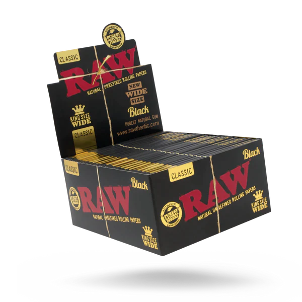 Front angled view of the RAW Classic King Size Wide Rolls 12-count display box in natural kraft brown packaging with red branding. This retail-ready display box provides smoke shops with an eye-catching countertop presentation for premium unrefined rolling papers.