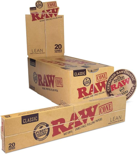 Angled overhead view of the RAW Classic Lean Cones 110mm 12-count display box in natural brown. Showcasing the opened retail display, this box neatly presents twelve individual 20-packs for easy countertop purchasing.