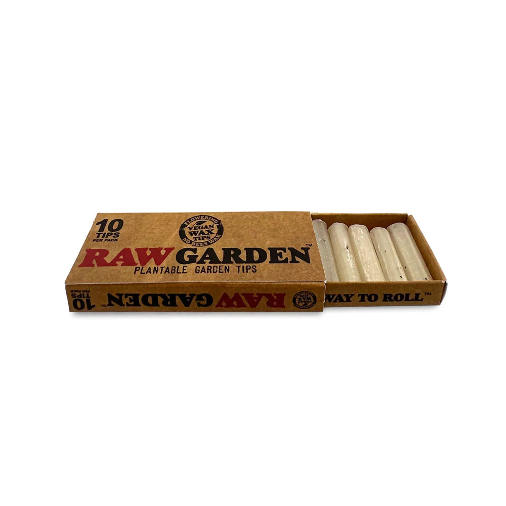 Angled overhead view of the RAW Garden Tips Plantable Wax Seed 10-count display box in natural brown and green. Revealing the opened retail carton, this presentation neatly arranges ten individual seed-embedded tip packages for easy customer browsing.