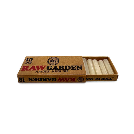 Angled overhead view of the RAW Garden Tips Plantable Wax Seed 10-count display box in natural brown and green. Revealing the opened retail carton, this presentation neatly arranges ten individual seed-embedded tip packages for easy customer browsing.