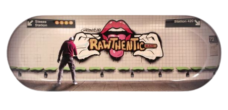 Top down view of the RAW Graffiti 2 Skate Tray. This skateboard deck-shaped rolling tray features a vivid subway-style brick wall graphic and curved lips to keep materials contained during prep.