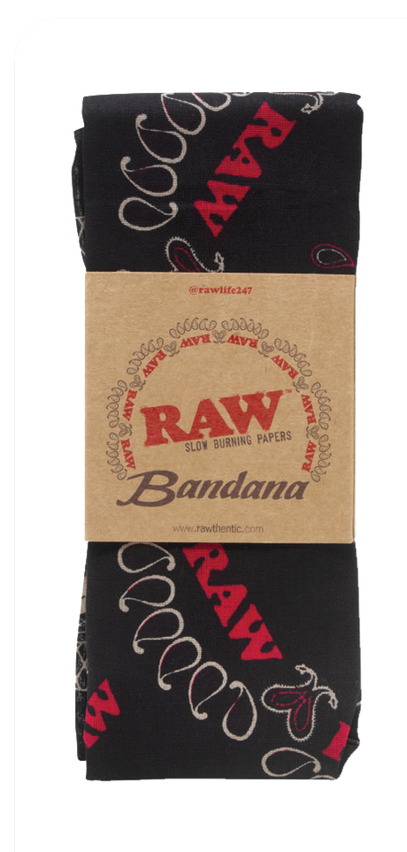Top down flat lay view of the RAW Hemp Paisley Bandana in classic black with a distressed white paisley print pattern. This premium lifestyle apparel piece features custom branded graphics woven into the design, serving as a stylish headwrap or smoke shop wall hanging.