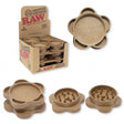 Front angled view of the RAW Hemp Plastic 2-Piece Gripper Grinder 12-count display box in natural kraft brown packaging. Made from an eco-friendly hemp composite, this retail-ready box provides smoke shops with an attractive, eco-conscious countertop presentation.