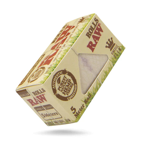 Front angled view of the RAW Organic Hemp Rolls 5-Meter King Size Slim 24-count box in natural light brown packaging with green and red branding. This retail-ready display box provides smoke shops with an eye-catching countertop presentation for premium unrefined hemp papers.