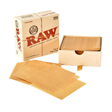 Angled overhead view of the open RAW Parchment Squares 500-count box in natural brown. Showcasing the bulk supply of 3x3 inch light brown sheets, this convenient dispenser box provides extractors and dabbers with quick, easy access to pre-cut non-stick paper.