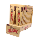 Angled overhead view of the open RAW Peacemaker cones display box revealing the individual 3-packs. The natural unbleached brown wrappers are capable of comfortably holding up to 2.25 grams of ground material.