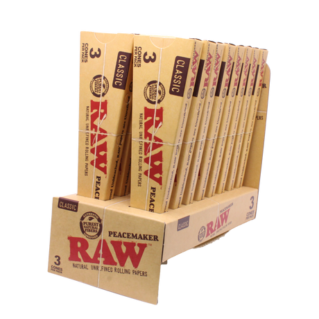 Angled overhead view of the open RAW Peacemaker cones display box revealing the individual 3-packs. The natural unbleached brown wrappers are capable of comfortably holding up to 2.25 grams of ground material.