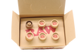 Angled overhead view of the open RAW pre-rolled rose tips box in kraft brown. These ready-to-use pre-rolled filters save consumers time while providing a rigid, structurally sound mouthpiece for custom rolls.