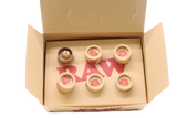 Angled overhead view of the open RAW pre-rolled rose tips box in kraft brown. These ready-to-use pre-rolled filters save consumers time while providing a rigid, structurally sound mouthpiece for custom rolls.