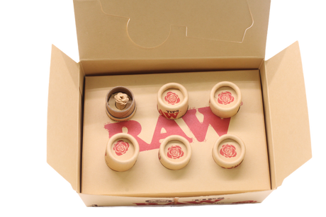 Angled overhead view of the open RAW pre-rolled rose tips box in kraft brown. These ready-to-use pre-rolled filters save consumers time while providing a rigid, structurally sound mouthpiece for custom rolls.
