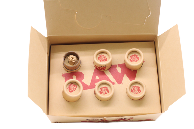 Angled overhead view of the open RAW pre-rolled rose tips box in kraft brown. These ready-to-use pre-rolled filters save consumers time while providing a rigid, structurally sound mouthpiece for custom rolls.