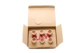 Angled overhead view of the open RAW pre-rolled rose tips box in kraft brown. These ready-to-use pre-rolled filters save consumers time while providing a rigid, structurally sound mouthpiece for custom rolls.