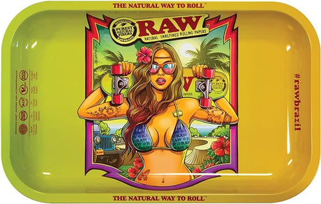 Front view of the small RAW Brazil V2 rolling tray in a multi-colored finish featuring a vibrant pop-art illustration of a roller-skating woman. This limited-edition 11×7-inch metal accessory provides an ultra-smooth workspace for breaking down dry herbs and rolling custom papers.