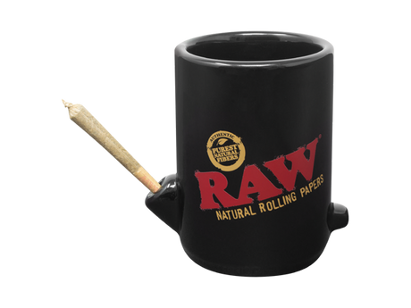 Front view of the RAW Wake Up Bake Up mug in matte black. This 2-in-1 ceramic coffee cup features a built-in dry herb bowl and mouthpiece, allowing users to sip their brew and smoke simultaneously for a relaxing morning routine.