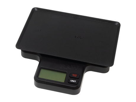 Angled front view of the RAW x My Weigh tray scale in its retail packaging. This multi-functional 1000g digital scale features a variable-sensitivity base explicitly contoured to hold the included metal mini rolling tray.