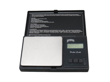 Angled top-down view of the Ricky and Morty digital pocket scale with the protective graphic lid opened. The durable stainless steel platform provides a perfectly flat, easy-to-clean surface for weighing dry herbs and concentrates with