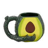 Front view of the Roast and Toast novelty mug pipe in the colors and shape of an avocado. This 2-in-1 functional ceramic coffee mug features a built-in dry herb pipe for the ultimate wake and bake session.
