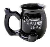 Front view of the Roast and Toast novelty mug pipe in black with white lettering. This 2-in-1 functional ceramic coffee mug features a built-in dry herb pipe for the ultimate wake and bake session.