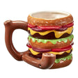 Front view of the Roast and Toast novelty mug pipe in burger. This 2-in-1 functional ceramic coffee mug features a built-in dry herb pipe for the ultimate wake and bake session.