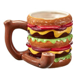 Front view of the Roast and Toast novelty mug pipe in burger. This 2-in-1 functional ceramic coffee mug features a built-in dry herb pipe for the ultimate wake and bake session.