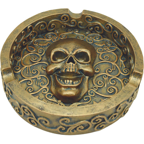 Angled front view of the Royal Bronze Skull Polystone Ashtray in a metallic bronze finish. This highly detailed, heavy-duty resin ashtray serves as both a functional smoking accessory and a striking piece of gothic home decor.