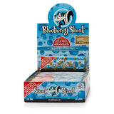 Front view of the Skunk Brand flavored rolling papers 1 1/4 size 24-count display box in a vibrant multicolored aesthetic with the iconic skunk logo. This wholesale countertop display case contains a sweet variety of slow-burning hemp papers designed to take the bite out of harsh herbs.