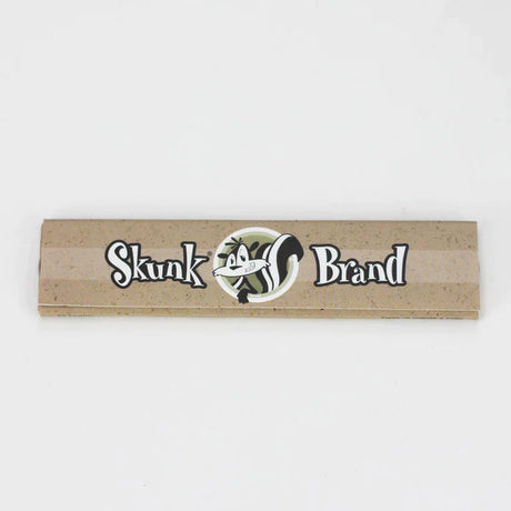 Front profile view of a single Skunk Brand King Size Slim rolling paper booklet showcasing the purple background and black accents. These classic unflavored sheets are made from 100% pure hemp to deliver a clean, smooth, and authentic smoking session.