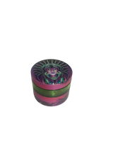 Side profile view of a closed Smoke Zilla Magnetic Grinder featuring a skull and sunglasses decal against a black base. The durable exterior is crafted with textured ridges along the top lid to provide users with a non-slip ergonomic grip for effortless twisting.