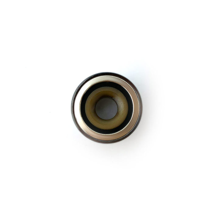Top-down view into the opened Stone Smiths' Slash Vaporizer heating chamber, featuring a white interior against a black exterior. The coil-less ceramic bowl evenly distributes heat to prevent a burning taste and offers a smooth 1-step cleaning process.