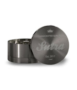 Angled front view of the Sutra Aluminum 4-piece 65mm herb grinder in a matte black finish. Equipped with a strong neodymium magnetic closure, this durable tool keeps your stash secure and prevents accidental spills during transport.