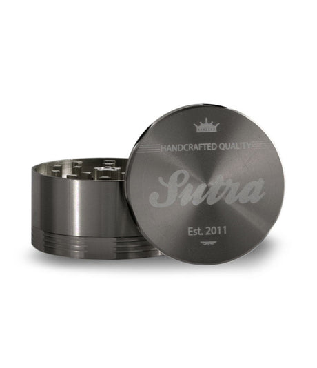 Angled front view of the Sutra Aluminum 4-piece 65mm herb grinder in a matte black finish. Equipped with a strong neodymium magnetic closure, this durable tool keeps your stash secure and prevents accidental spills during transport.