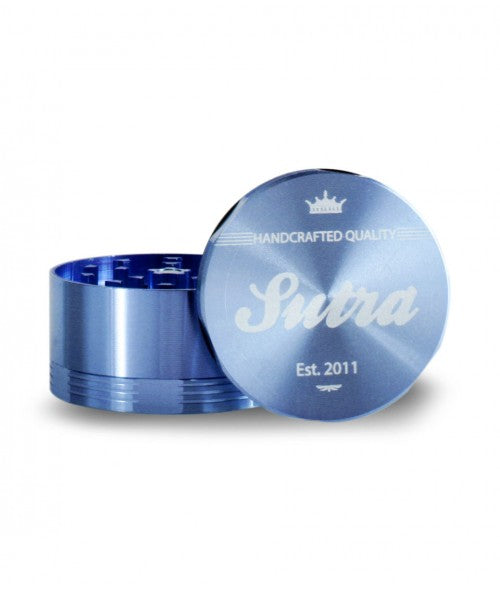 Angled front view of the Sutra Aluminum 4-piece 65mm herb grinder in a metallic blue finish. This heavy-duty aircraft-grade aluminum crusher features an ergonomic grip design that allows for effortless shredding of dense dry herbs.