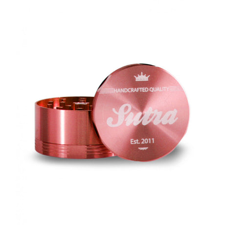 Angled front view of the Sutra Aluminum 4-piece 65mm herb grinder in a deep metallic red finish. This multi-tiered pocket crusher includes a built-in stainless steel mesh screen to cleanly sift out and collect fine pollen particles.