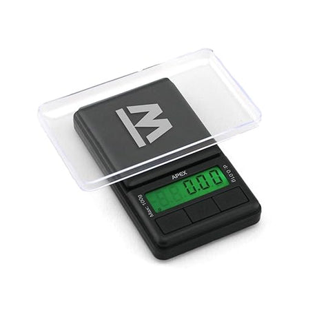 Angled overhead view of the Truweigh Apex digital mini scale in black. This ultra-compact 100g x 0.01g pocket scale features a stainless steel platform for highly precise weighing of herbs, concentrates, and small jewelry.