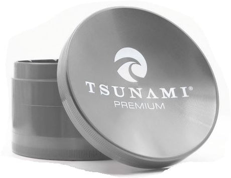 Front view of the Tsunami 100mm sunken top herb grinder in sleek silver. This extra-large, premium aluminum grinder features a unique bowl-shaped top perfect for conveniently mixing and rolling your dry herbs.