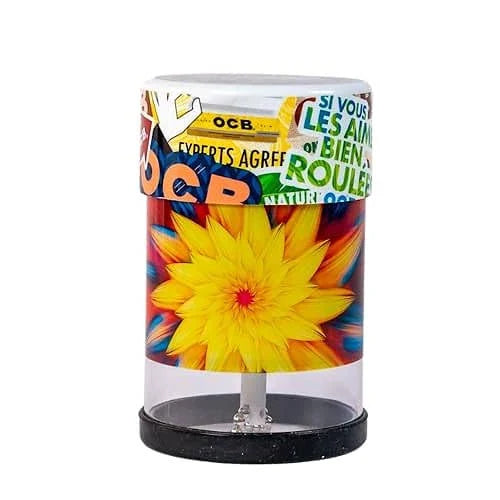 Front view of the Wakit Grinders KLR Series electric grinder featuring a vibrant multicolored floral pattern on a black base. This revolutionary rechargeable grinder uses a patented ball-and-chain mechanism to effortlessly prep your dry herbs in seconds.