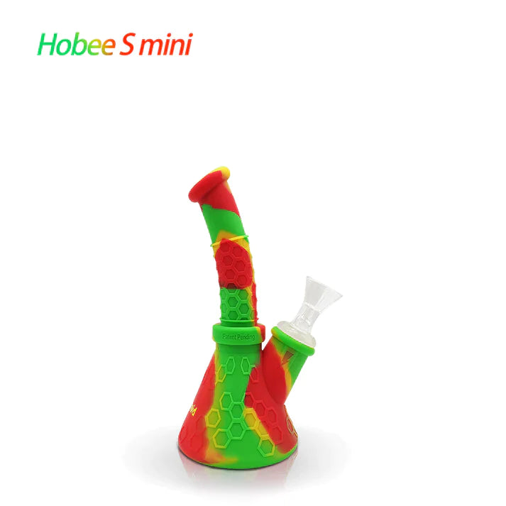 Front profile view of the Waxmaid 8.5 Inch Hobee's Silicone Beaker Water Pipe in vibrant rasta red, yellow, and green. This platinum-cured silicone water pipe features a traditional beaker design that is completely unbreakable for reliable travel use.