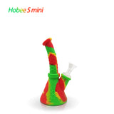 Front profile view of the Waxmaid 8.5 Inch Hobee's Silicone Beaker Water Pipe in vibrant rasta red, yellow, and green. This platinum-cured silicone water pipe features a traditional beaker design that is completely unbreakable for reliable travel use.