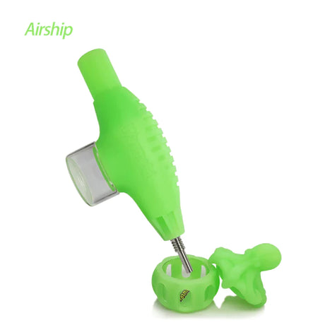 Front angled view of the Waxmaid Airship Silicone Nectar Collector Kit in a vibrant glow in the dark green. This futuristic space-themed dab straw kit includes a durable silicone body and a medical-grade titanium nail tip for smoothly vaporizing solid wax and essential oils.