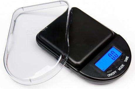 Angled overhead view of the Weighmax PX digital pocket scale in black and silver. This compact 650g x 0.1g scale features a stainless steel platform for precise, on-the-go weighing of herbs, jewelry, and small items.